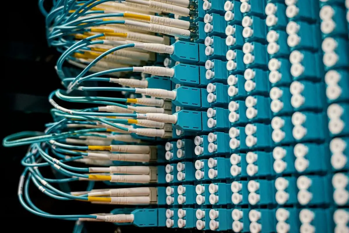 Close-up view of a fiber optic patch panel with multiple connected cables.
